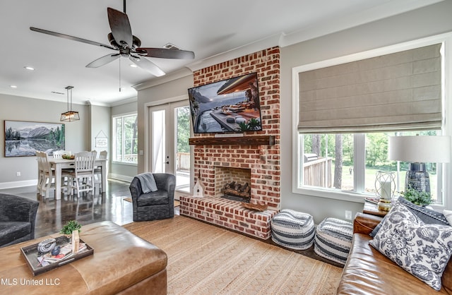 150 Pine Ridge Cir, Brandon, MS 39047 - living area featuring a fireplace, ceiling fan, baseboards, ornamental molding, and wood finished floors