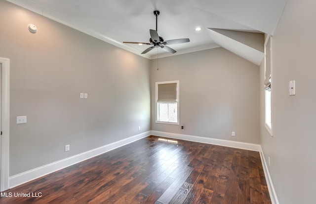 150 Pine Ridge Cir, Brandon, MS 39047 - spare room with dark wood-type flooring, lofted ceiling, a ceiling fan, and baseboards