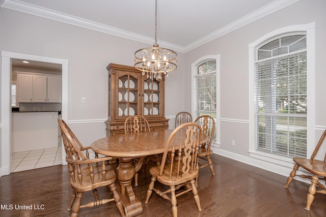 dining area featuring dark wood-type flooring, crown molding, and an inviting chandelier