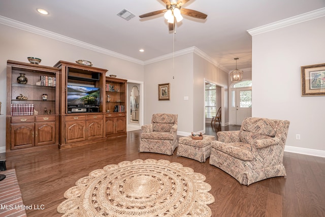 living room featuring ornamental molding, dark hardwood / wood-style floors, and ceiling fan with notable chandelier