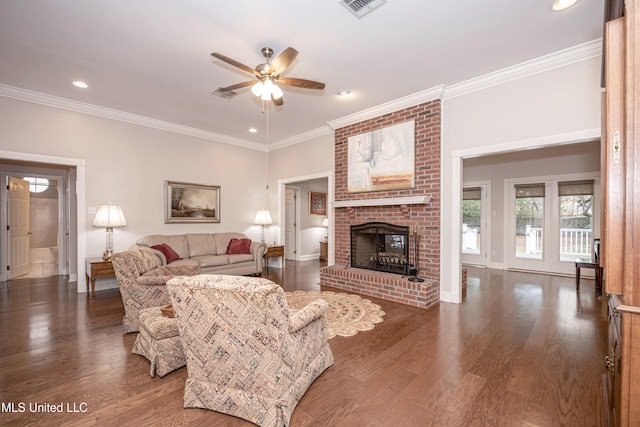 living room featuring ornamental molding, a fireplace, dark wood-type flooring, and ceiling fan