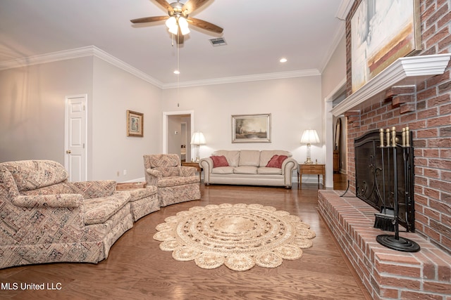 living room featuring a brick fireplace, ornamental molding, ceiling fan, and wood-type flooring