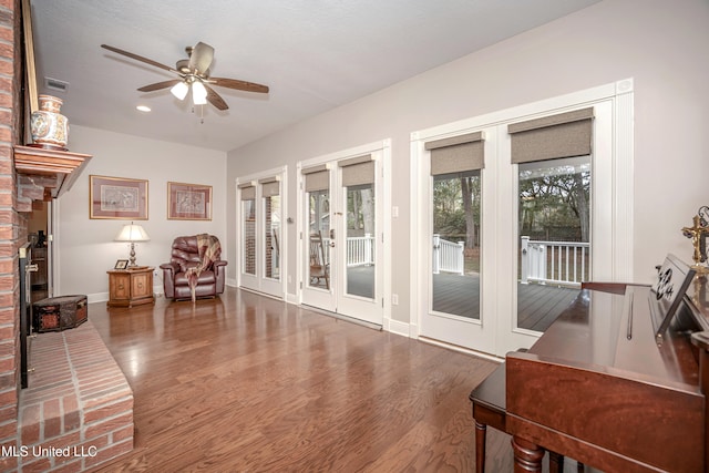 interior space with dark wood-type flooring and ceiling fan