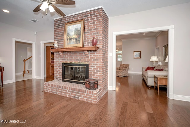 3607 Dijon Ave, Ocean Springs, MS 39564 - living room featuring a ceiling fan, a brick fireplace, wood finished floors, baseboards, and stairs