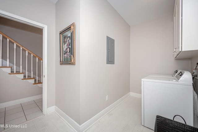 laundry room featuring electric panel, cabinets, and separate washer and dryer