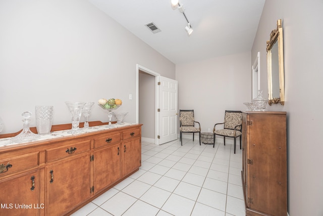 sitting room featuring track lighting and light tile patterned flooring