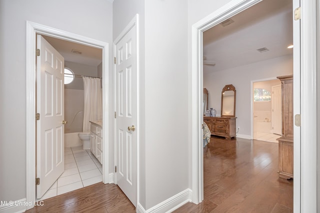 corridor with light wood-type flooring