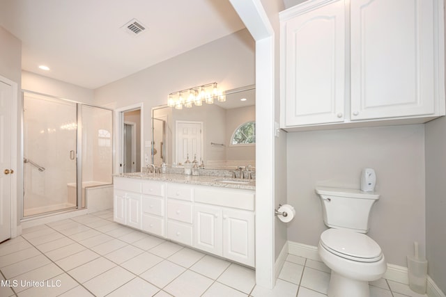 bathroom featuring toilet, vanity, tile patterned flooring, and a shower with shower door