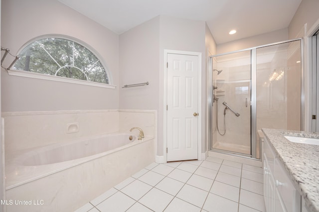 bathroom with tile patterned flooring, vanity, and plus walk in shower