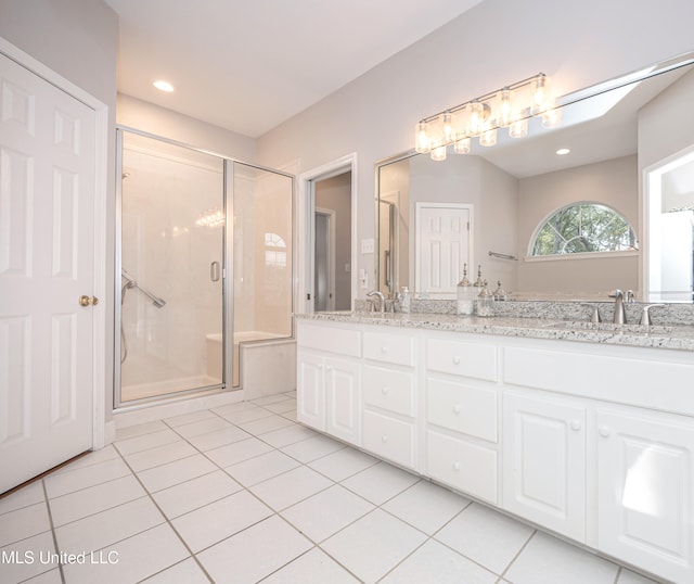 bathroom with vanity, tile patterned floors, and a shower with shower door