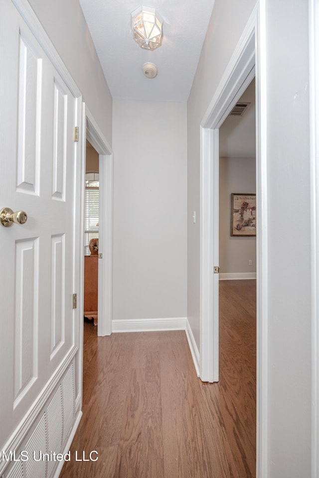 corridor with light hardwood / wood-style flooring