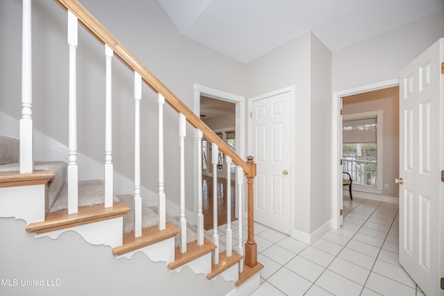 staircase featuring tile patterned floors