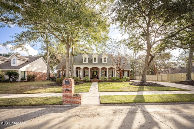 3607 Dijon Ave, Ocean Springs, MS 39564 - cape cod-style house featuring a porch and brick siding