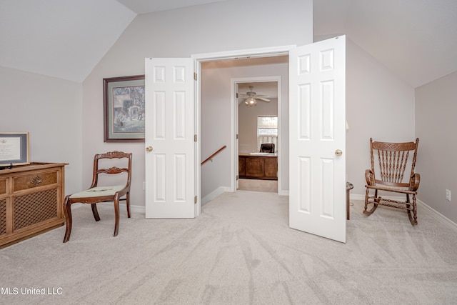 living area featuring lofted ceiling, light carpet, and ceiling fan