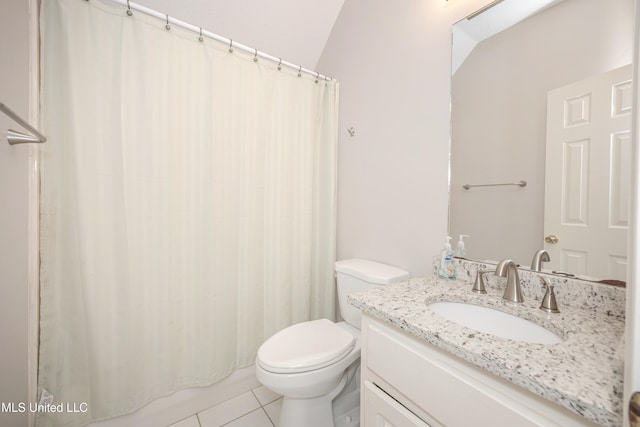 bathroom with toilet, vaulted ceiling, tile patterned flooring, vanity, and walk in shower