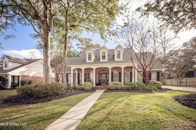 3607 Dijon Ave, Ocean Springs, MS 39564 - cape cod house featuring brick siding, roof with shingles, and a porch