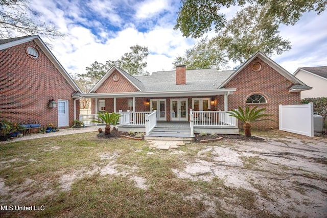 3607 Dijon Ave, Ocean Springs, MS 39564 - view of front of house featuring brick siding, french doors, a chimney, and a porch