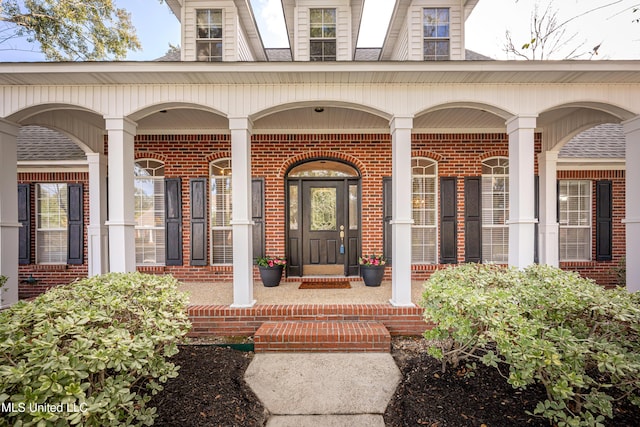 3607 Dijon Ave, Ocean Springs, MS 39564 - property entrance with brick siding, covered porch, and a shingled roof