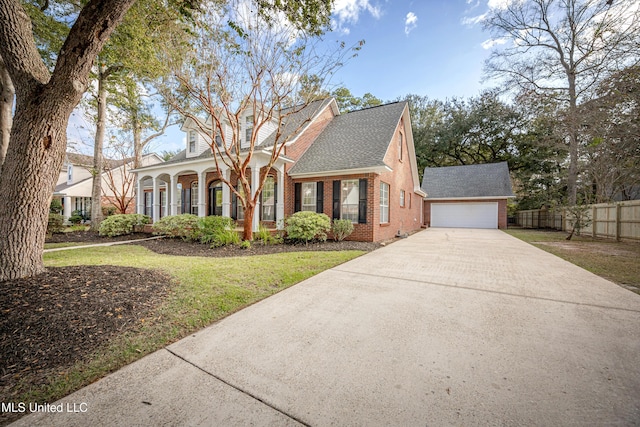 3607 Dijon Ave, Ocean Springs, MS 39564 - new england style home featuring brick siding, a shingled roof, concrete driveway, a garage, and an outdoor structure