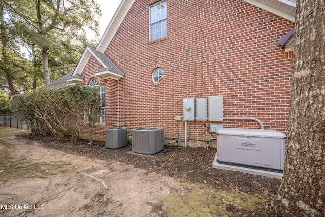 view of side of home with central air condition unit