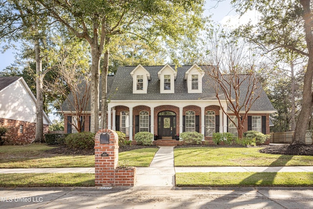 3607 Dijon Ave, Ocean Springs, MS 39564 - cape cod house with brick siding, roof with shingles, and a front yard