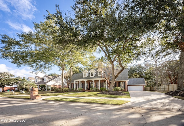 cape cod-style house with a front lawn and a garage