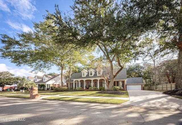 3607 Dijon Ave, Ocean Springs, MS 39564 - cape cod home with driveway, brick siding, and a porch