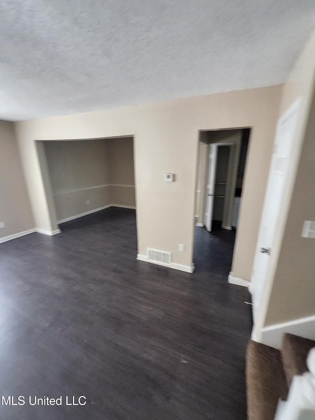 10101 Stephenson Ln, Olive Branch, MS 38654 - empty room featuring dark wood-style flooring and a textured ceiling
