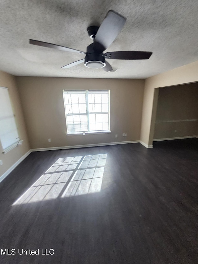 10101 Stephenson Ln, Olive Branch, MS 38654 - spare room with a textured ceiling, ceiling fan, and dark wood-style floors