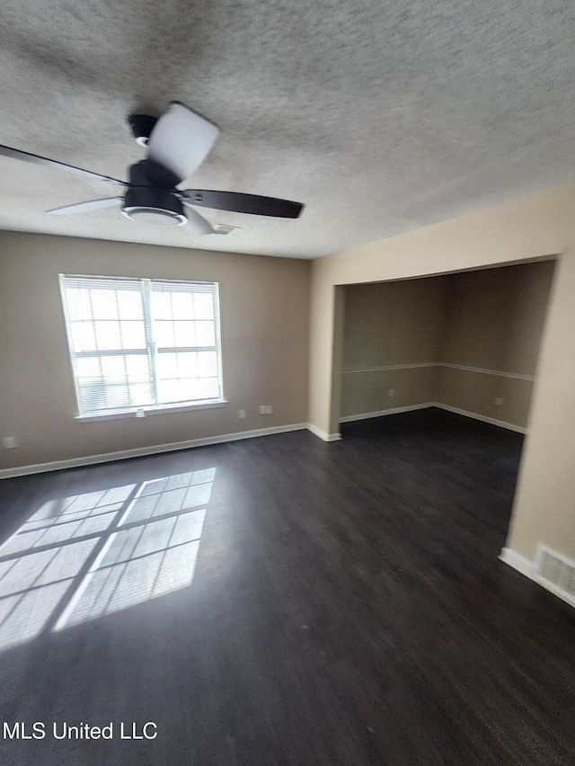 10101 Stephenson Ln, Olive Branch, MS 38654 - unfurnished living room featuring ceiling fan, dark wood-type flooring, and a textured ceiling