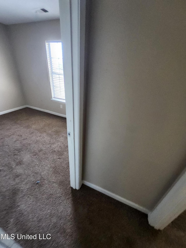 10101 Stephenson Ln, Olive Branch, MS 38654 - spare room with dark carpet and baseboards