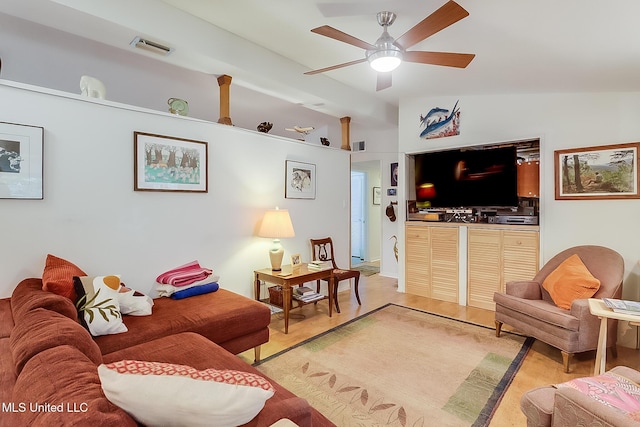 living room featuring lofted ceiling, light wood-type flooring, and ceiling fan