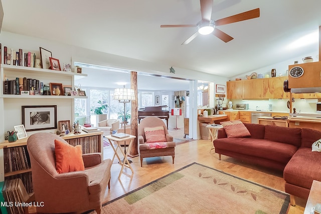 living room featuring vaulted ceiling and ceiling fan