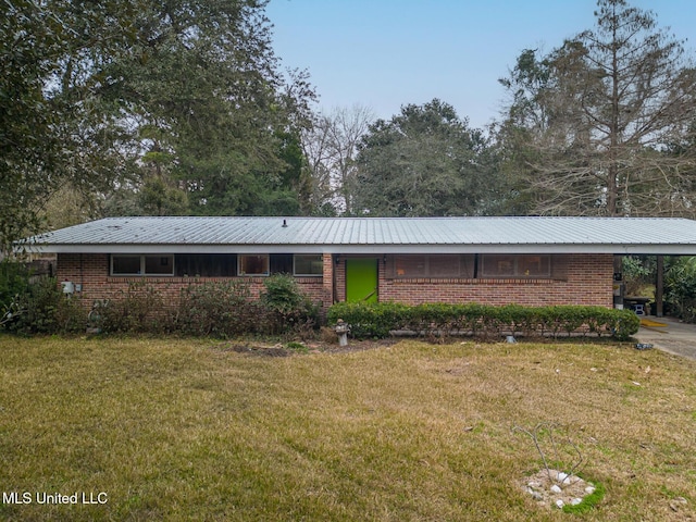 ranch-style home with a carport and a front lawn