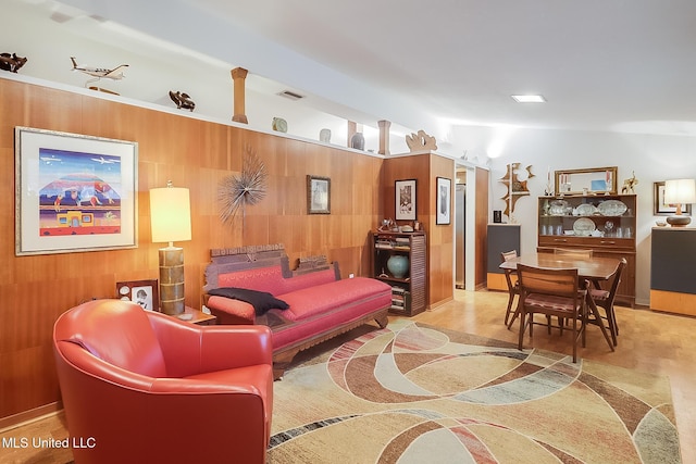 living room featuring wood walls