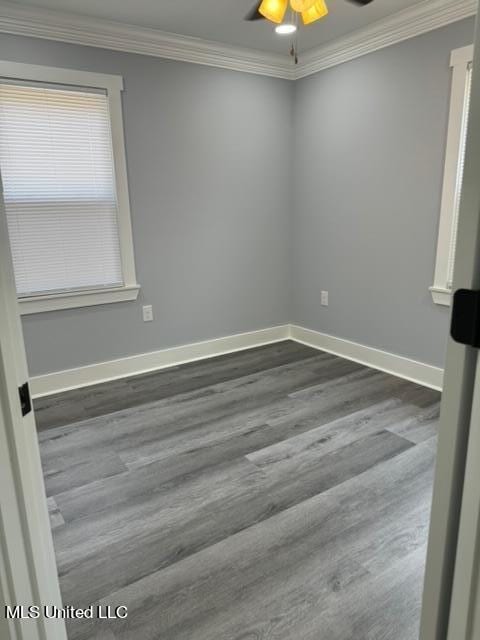 unfurnished room featuring ornamental molding, dark hardwood / wood-style floors, and ceiling fan