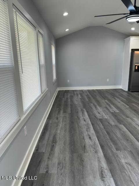 spare room featuring ceiling fan, lofted ceiling, and dark hardwood / wood-style flooring