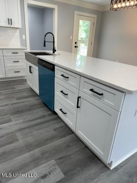 kitchen with dark wood-type flooring, black dishwasher, sink, and white cabinets