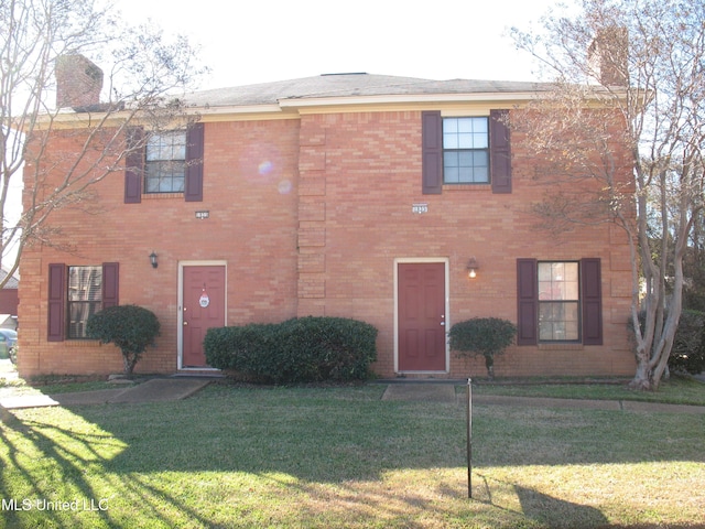 colonial home with a front lawn