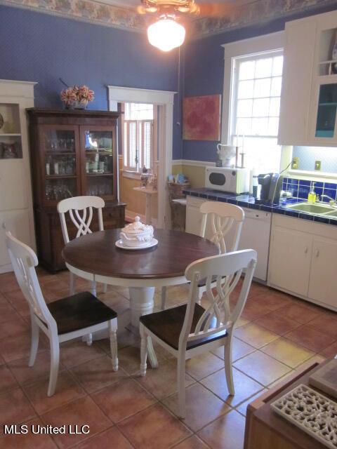 400 Crockett Ave, Greenwood, MS 38930 - dining space with light tile patterned flooring, sink, and a healthy amount of sunlight