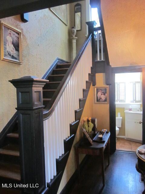 400 Crockett Ave, Greenwood, MS 38930 - stairs featuring sink and hardwood / wood-style floors