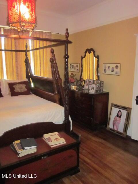 400 Crockett Ave, Greenwood, MS 38930 - bedroom with dark hardwood / wood-style flooring and a notable chandelier