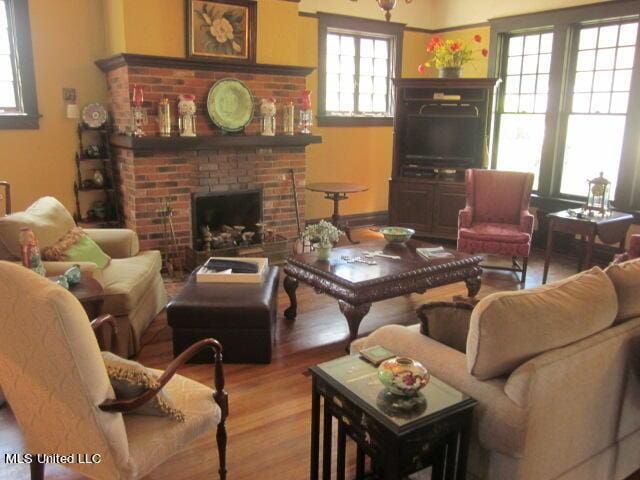 400 Crockett Ave, Greenwood, MS 38930 - living room with light hardwood / wood-style flooring and a brick fireplace