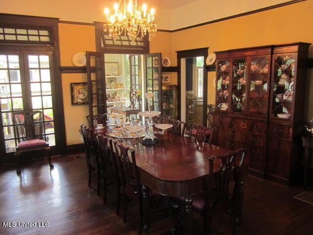 400 Crockett Ave, Greenwood, MS 38930 - dining space featuring french doors, an inviting chandelier, and dark hardwood / wood-style flooring