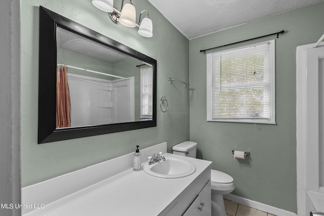 bathroom featuring tile patterned floors, vanity, a textured ceiling, and toilet