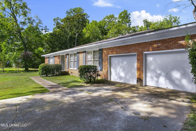 ranch-style home with a garage and a front lawn