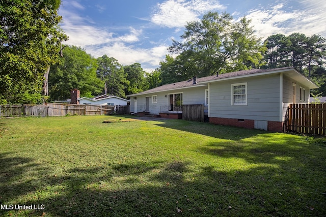 back of house with a yard