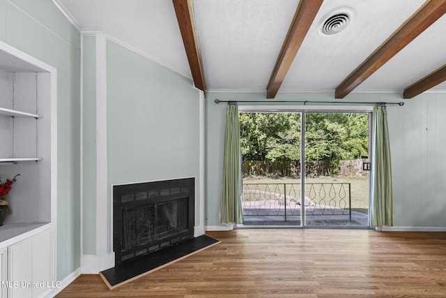 unfurnished living room with beamed ceiling and hardwood / wood-style floors