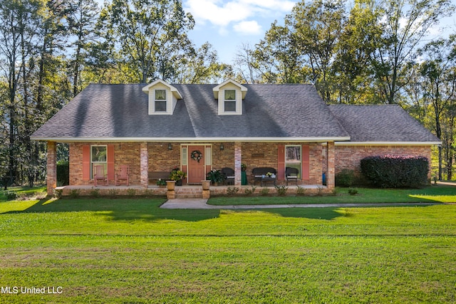 new england style home with a front lawn and covered porch