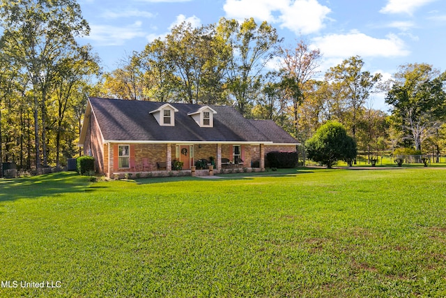 cape cod home featuring a front yard